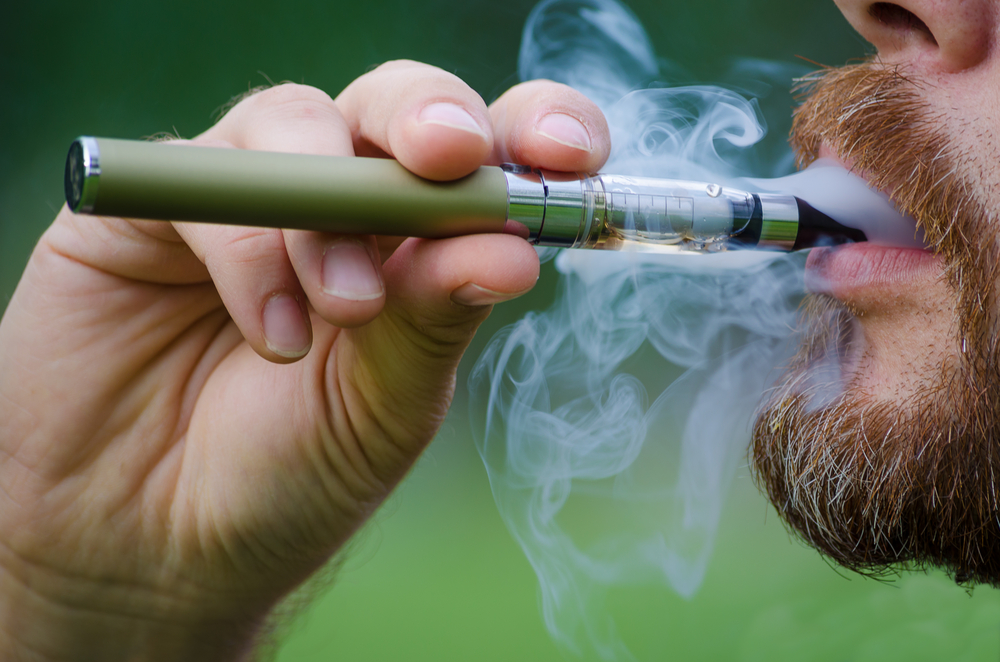 Close-up of a man vaping an electronic cigarette